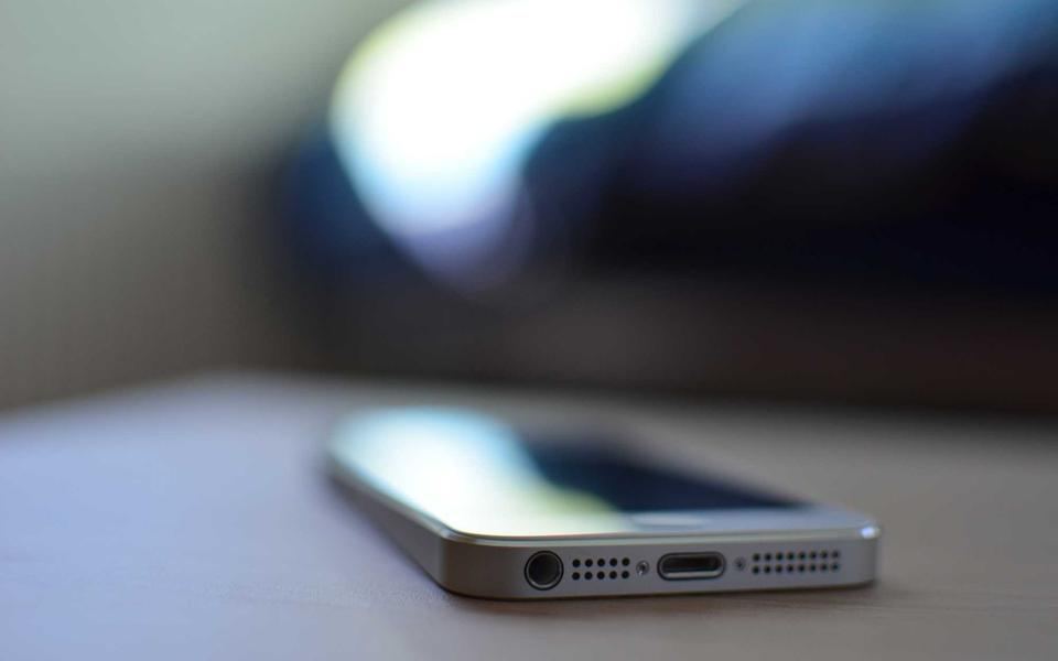 Primo piano di uno smartphone appoggiato su un tavolo, sfondo sfocato